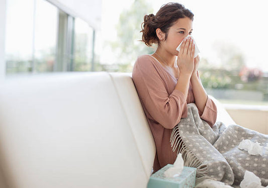 A woman covering her nose suffering from allergy