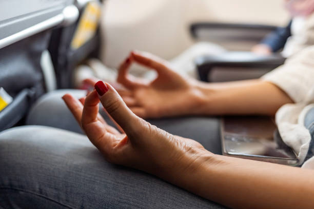 Close-up of a woman practicing meditation or deep breathing techniques to ease flight anxiety