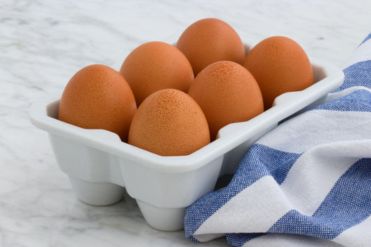 Eggs in Glass Carton on Countertop
