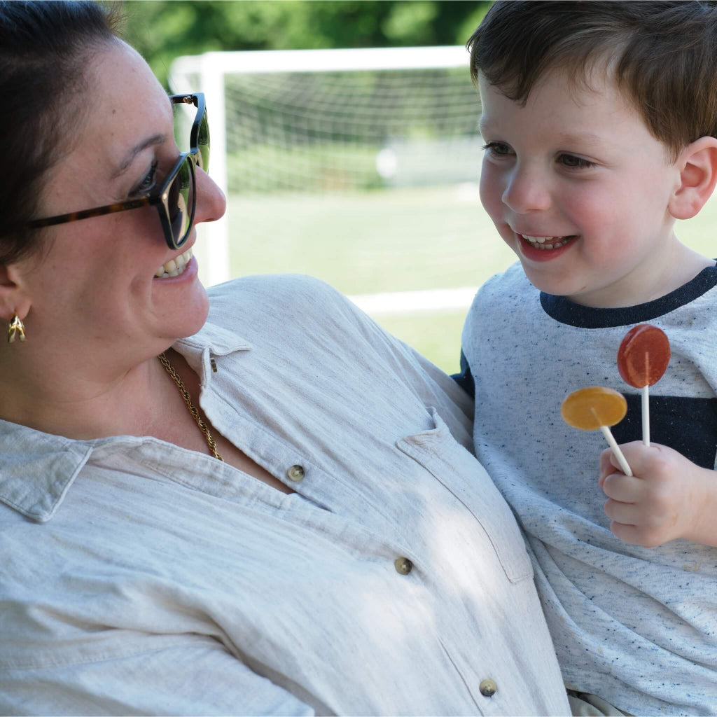 MommaBear Organics Allergy Care honey lollipops box for natural relief from seasonal symptoms enjoyed by mother and son